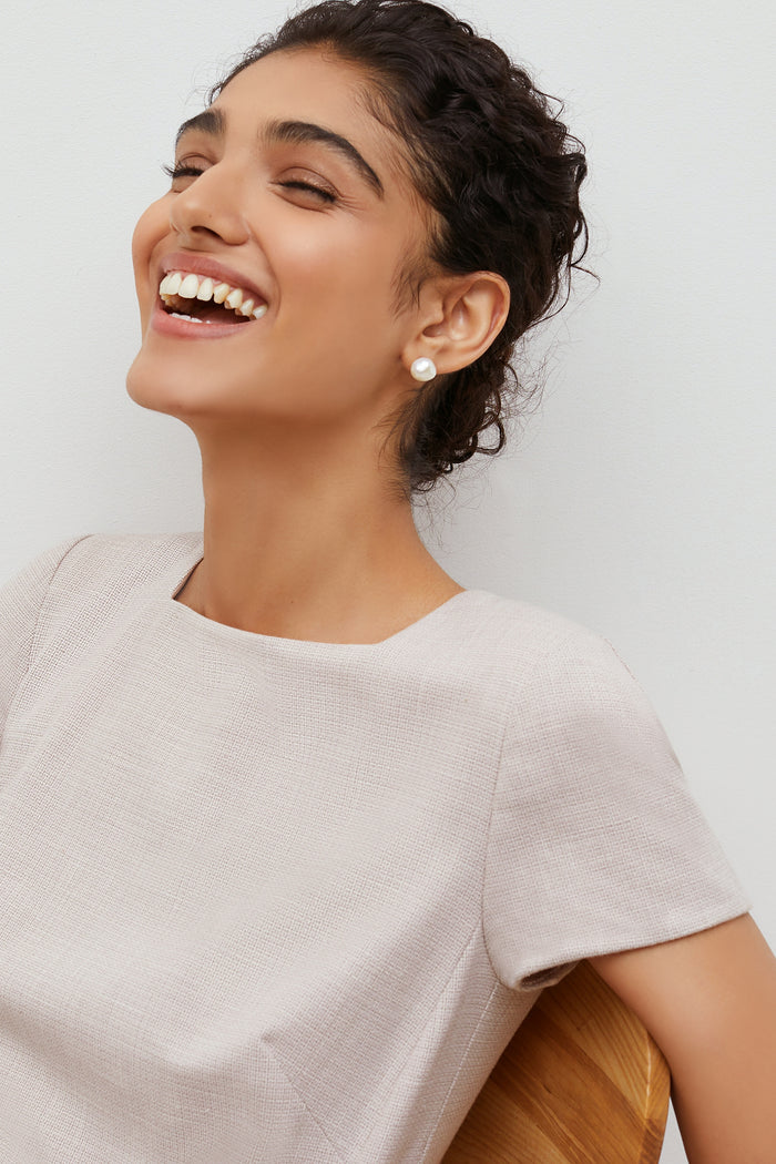 Detail image of a woman standing wearing the marie dress in crosshatch in dove | Grid Hover | Exclude