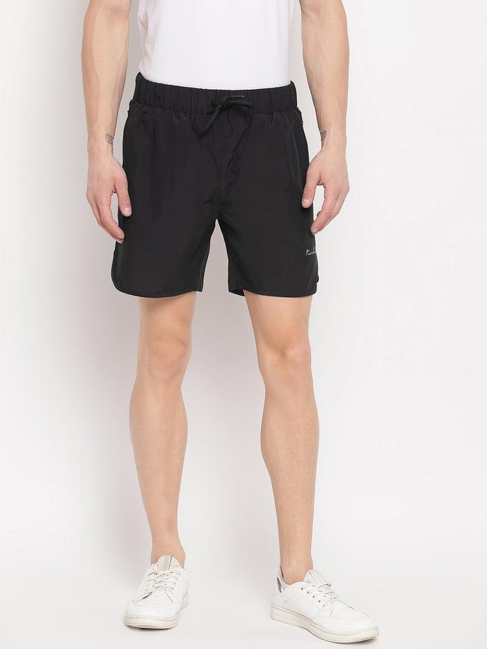 A man wearing black regular fit side pocket shorts and a white t-shirt.