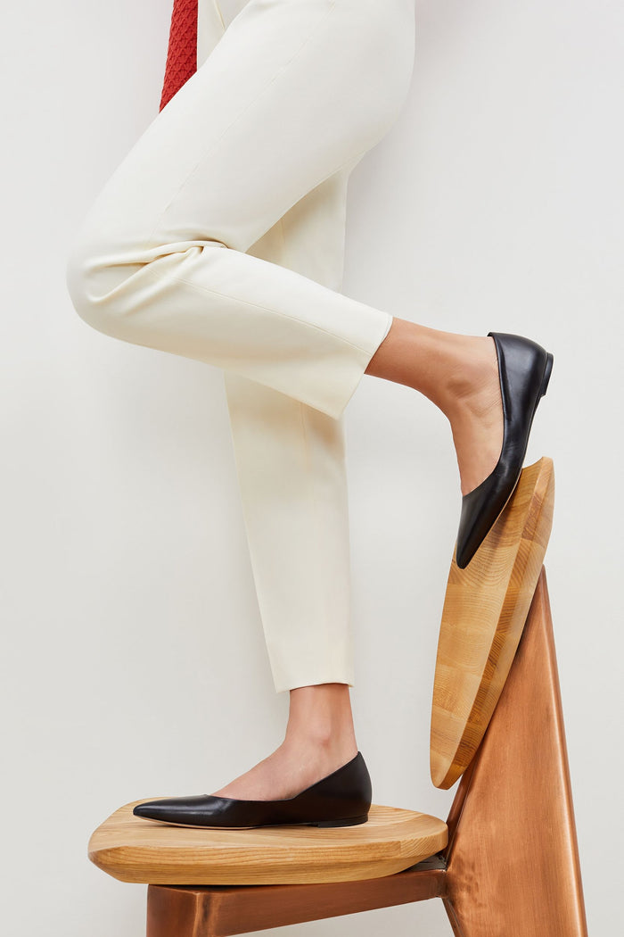 Side image of a woman standing wearing the Rowan Flat--Kidskin in Black | Grid Hover | Exclude