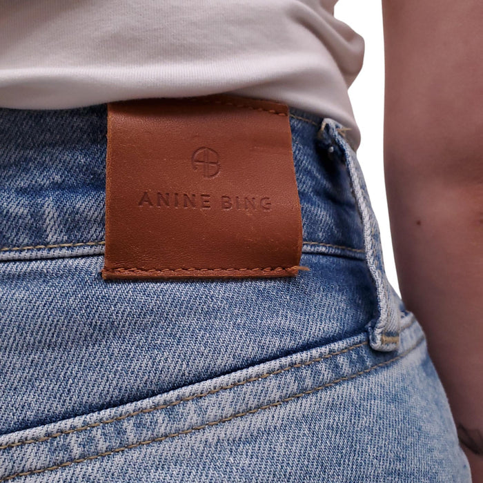 ANINE BING LIGHT WASH JEANS WITH SILVER LOGO BUTTONS - SIZE 24