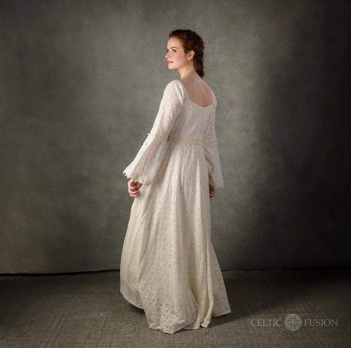 Side back studio view of the Bébhinn Boho Lace Wedding Dress, sustainable cotton lace gown with bell sleeves.