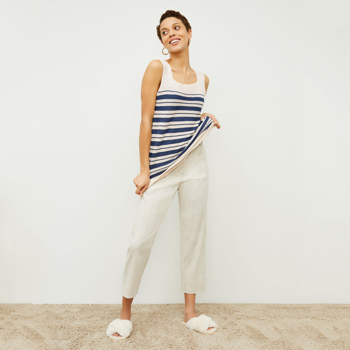 Front image of a woman standing wearing the Chester pant slubbed stretch linen in natural