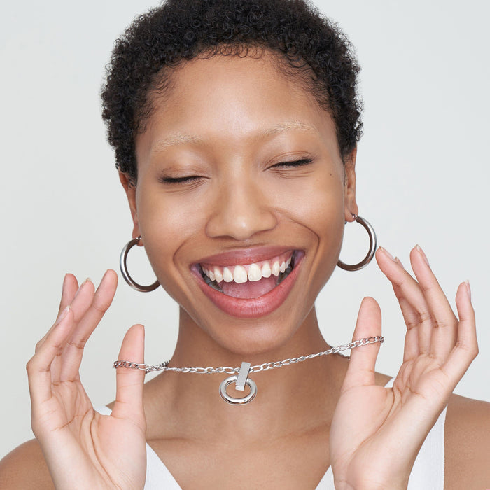 Detail image of a woman standing wearing the Claressa Earrrings Medium in Silver