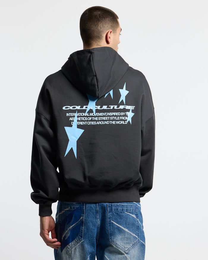 COSMOS ARC HOODIE INDIA INK - washed black star print hoodie, back view on male model - Cold Culture #man