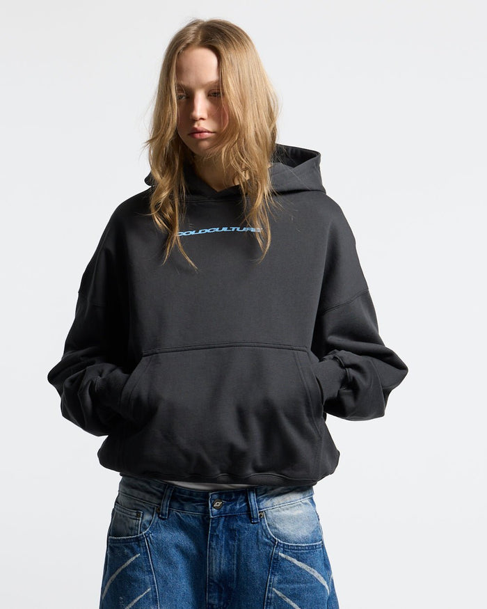 COSMOS ARC HOODIE INDIA INK - washed black star print hoodie, front view on female model - Cold Culture #woman