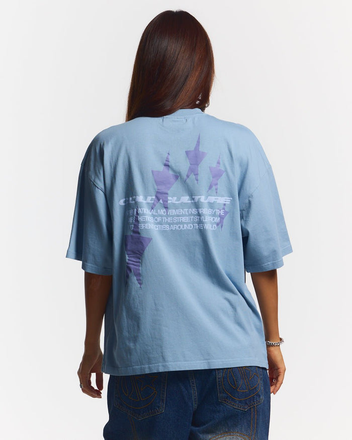 COSMOS ARC TEE SHADY BLUE - light blue oversized tee, back view on female model - Cold Culture #woman