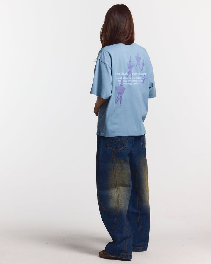 COSMOS ARC TEE SHADY BLUE - light blue oversized tee, back view on female model - Cold Culture #woman