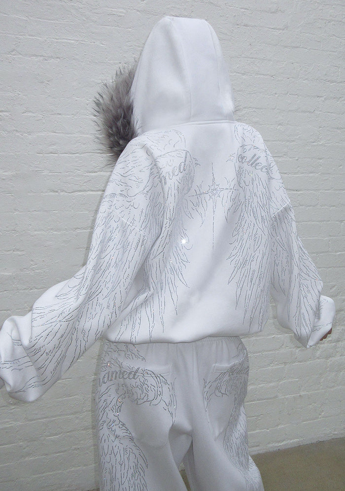 Back view of a white hoodie featuring a gray fur trim and rhinestone wing design on the back.