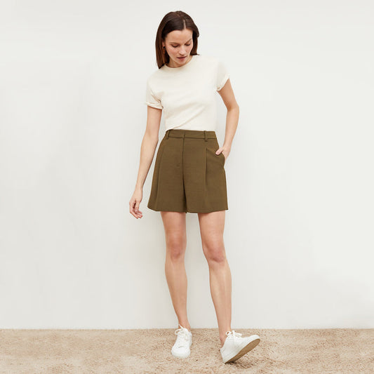 Front image of a woman standing wearing the Fletcher Short—Nep Suiting in Safari | Lead
