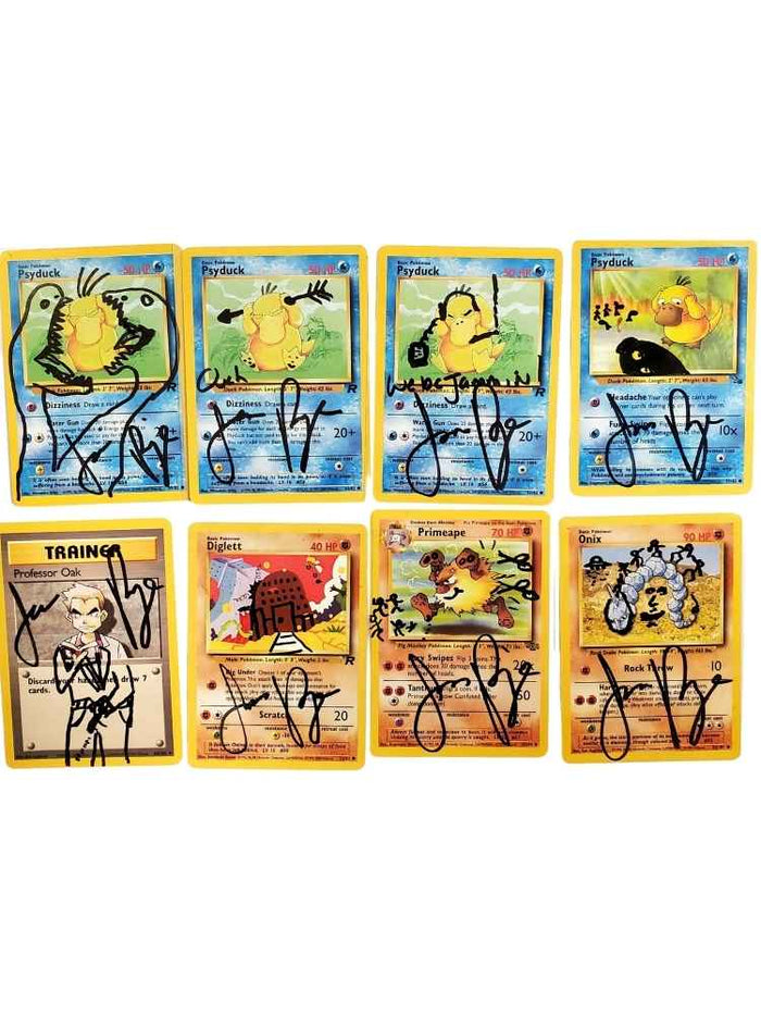 Set of eight autographed trading cards on a white background