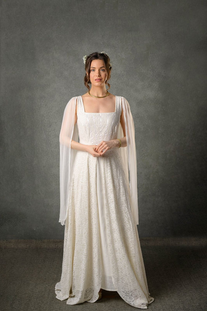 Ivory lace folklore wedding dress with square neckline, flowing chiffon drape sleeves and full-length bridal skirt