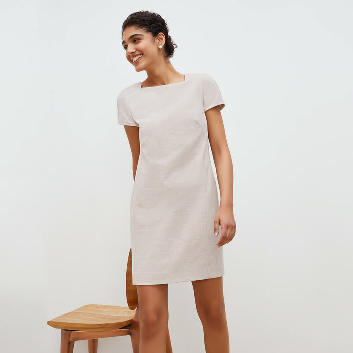 Front image of a woman standing wearing the marie dress in crosshatch in dove | Lead