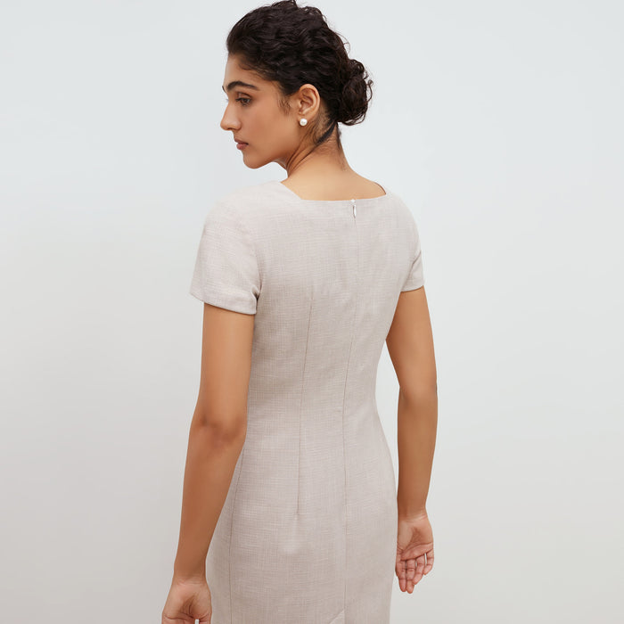 Back image of a woman standing wearing the marie dress in crosshatch in dove