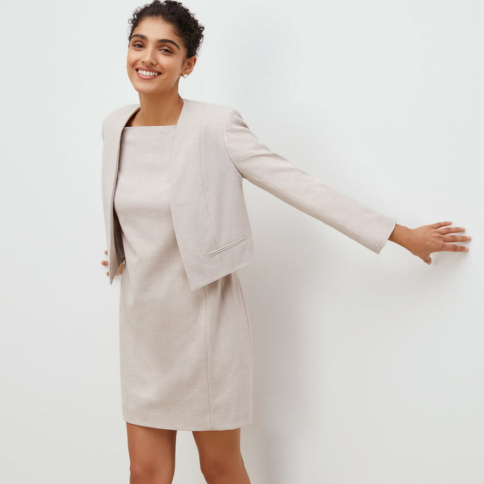 Front image of a woman standing wearing the marie dress in crosshatch in dove