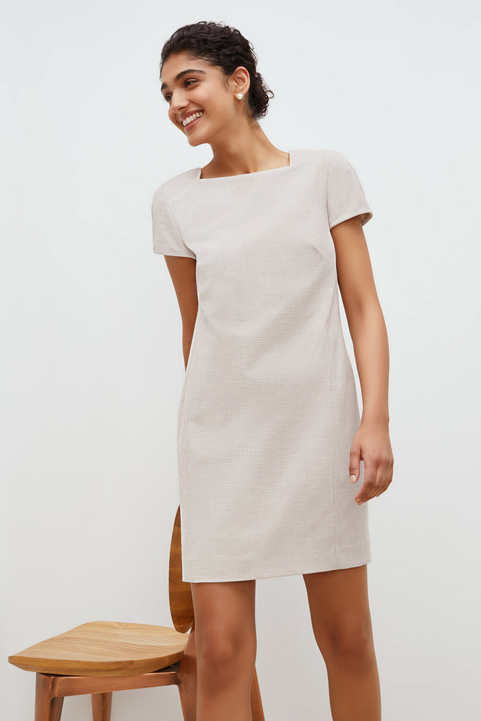 Front image of a woman standing wearing the marie dress in crosshatch in dove | Grid | Exclude