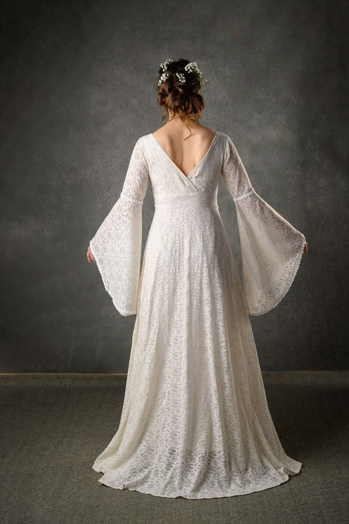 Back view of our natural bridal gown in ivory cotton, the perfect handfasting wedding dress with low V back, fitted waist and long bell sleeves