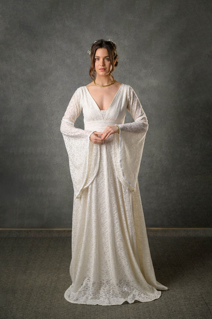 Celtic Fusion bridal gowns and Irish wedding dresses with sleeves designed in Ivory cotton lace with deep V neckline, long bell sleeves and full-length flowing skirt
