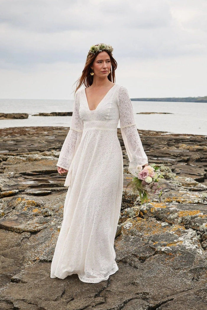 Ivory cotton natural wedding gown with sleeves and soft flowing skirt worn for a coastal bridal look in Ireland designed by Celtic Fusion