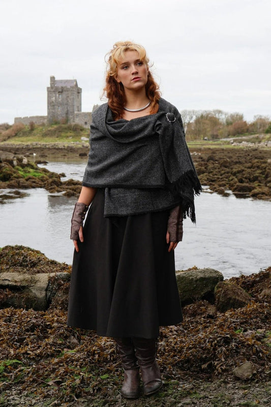 Full-length view of handwoven shawl styled with white metal Uisneach brooch in an Irish nature setting