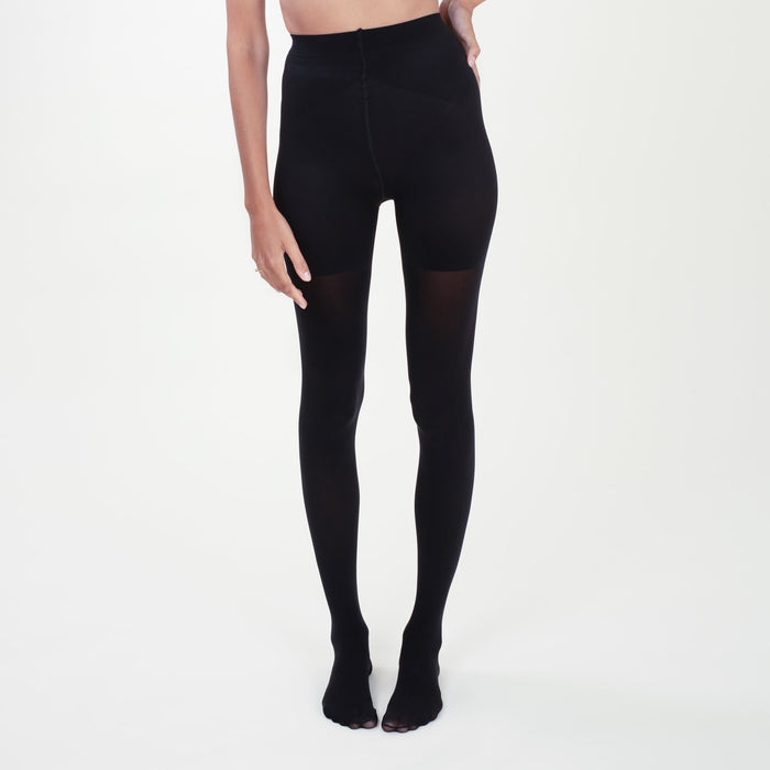 Front image of a woman standing wearing the Threads Opaque Tights in Black | Lead