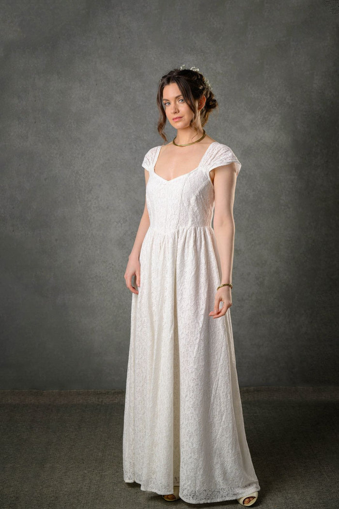 Floral cotton lace gown for bride with fitted corset bodice, gathered straps and romantic ivory silhouette